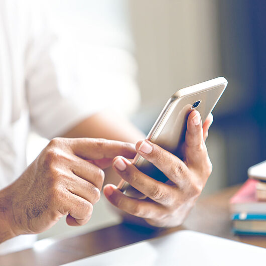Symbolic image shows hand with cell phone.